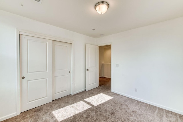 unfurnished bedroom with carpet and a closet