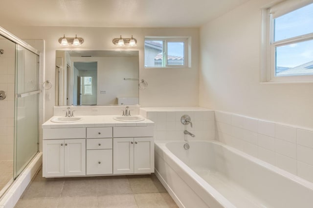 bathroom featuring tile patterned flooring, vanity, and separate shower and tub