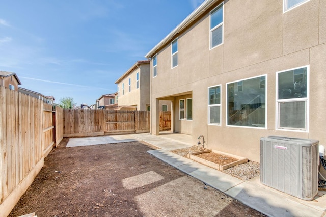 rear view of house with cooling unit and a patio area