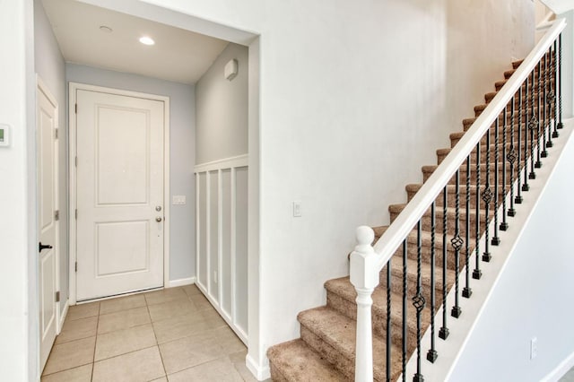 stairs featuring tile patterned flooring