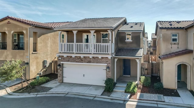 view of front facade featuring a balcony and a garage