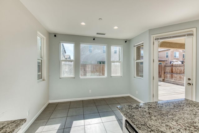 unfurnished dining area featuring light tile patterned flooring