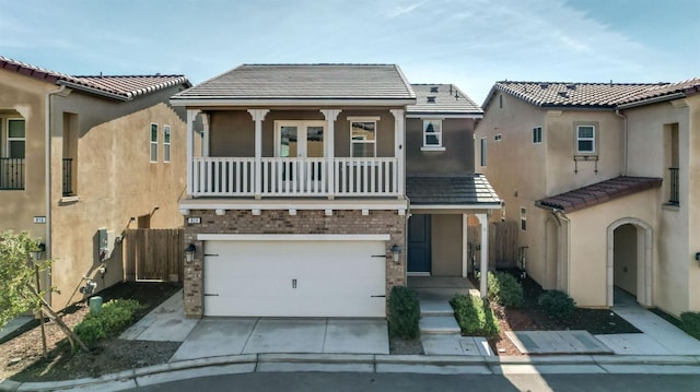 view of front facade with a balcony and a garage