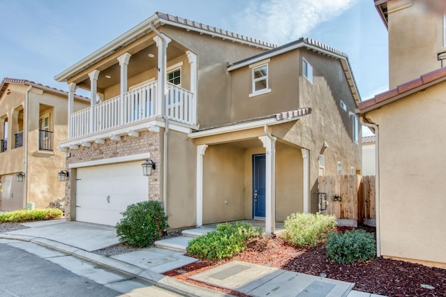 view of front of home with a balcony and a garage