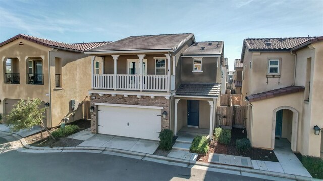 view of front of property featuring a balcony and a garage