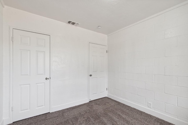 unfurnished bedroom featuring dark colored carpet