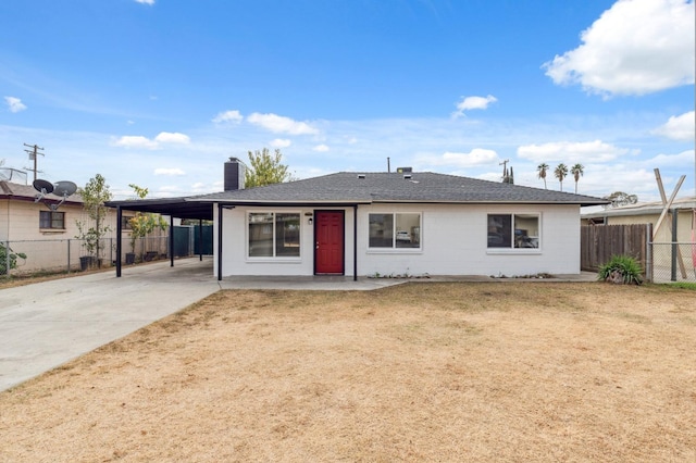 view of front facade with a carport and a front yard