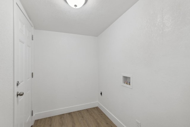 laundry room featuring hookup for an electric dryer, hardwood / wood-style floors, a textured ceiling, and hookup for a washing machine