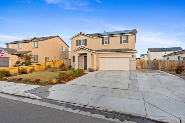 front of property with a garage and solar panels