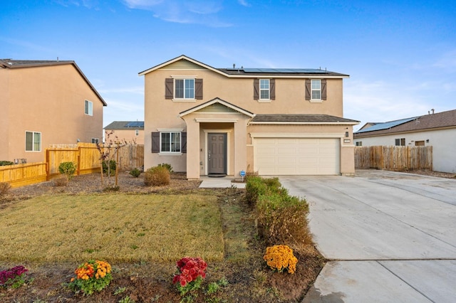 view of property featuring a front yard, solar panels, and a garage