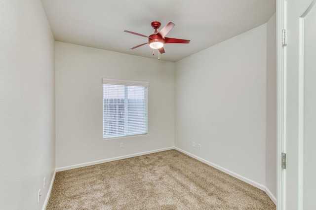 empty room featuring light colored carpet and ceiling fan