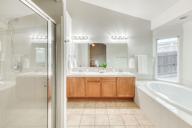 bathroom with tile patterned flooring, vanity, and separate shower and tub