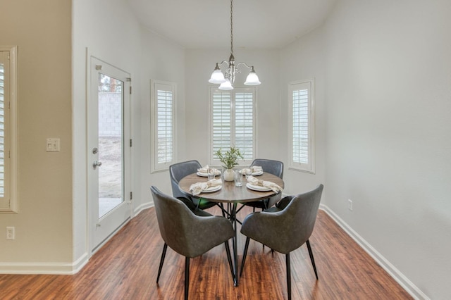 dining room featuring hardwood / wood-style floors and a notable chandelier