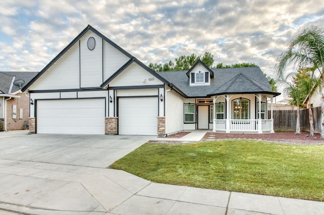 view of front of home featuring a porch, a garage, and a front lawn