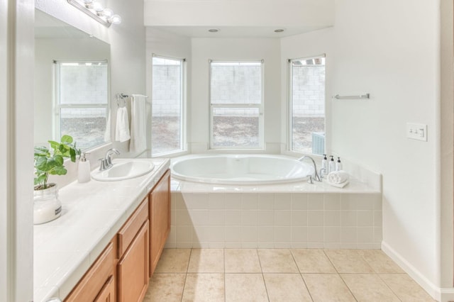 bathroom with vanity, tile patterned floors, and tiled bath