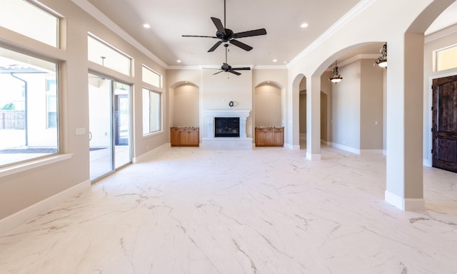 unfurnished living room featuring a tile fireplace, crown molding, and ceiling fan