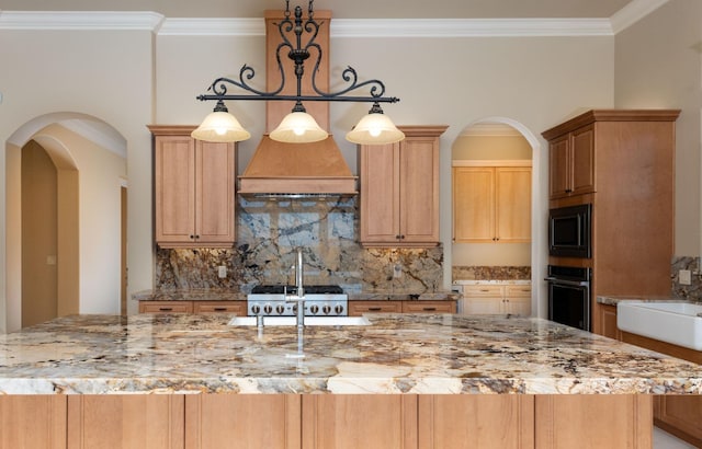 kitchen with oven, premium range hood, ornamental molding, arched walkways, and built in microwave