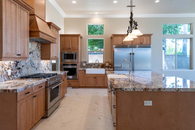 kitchen featuring built in appliances, premium range hood, crown molding, and a sink