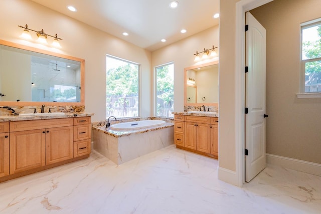 full bath featuring a wealth of natural light, a marble finish shower, a garden tub, and a sink