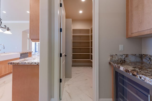 storage area featuring a sink and beverage cooler