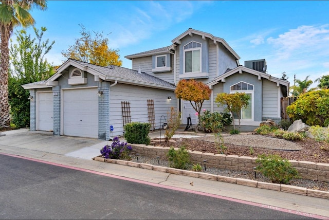 front facade featuring a garage and central AC