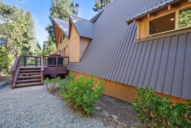 view of side of home featuring a wooden deck