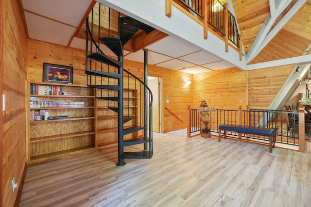 bonus room with wood walls, high vaulted ceiling, and wood-type flooring