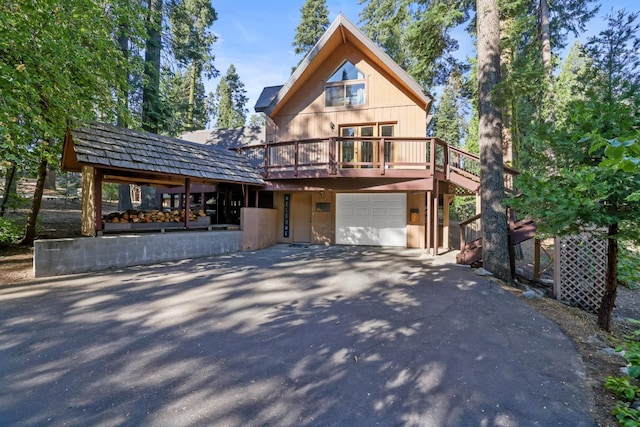 view of front of property featuring a garage and a wooden deck