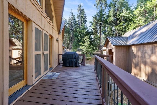 wooden terrace with a grill