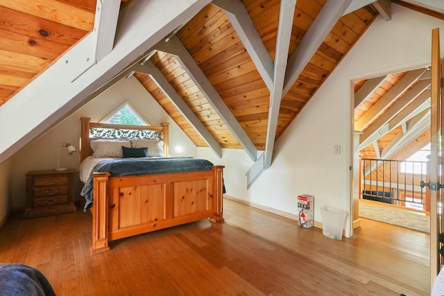 bedroom featuring hardwood / wood-style floors, vaulted ceiling with beams, and wooden ceiling