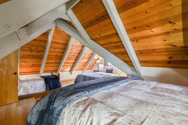 bedroom with vaulted ceiling with beams, wooden ceiling, and hardwood / wood-style flooring