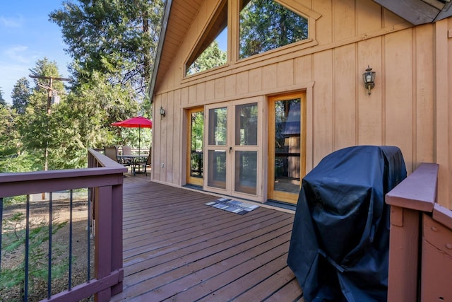 wooden terrace featuring a grill