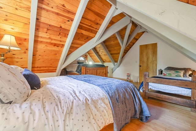 bedroom with hardwood / wood-style flooring, lofted ceiling with beams, and wood ceiling