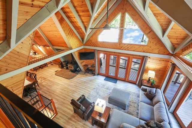 living room with wooden ceiling, high vaulted ceiling, beamed ceiling, wooden walls, and hardwood / wood-style flooring