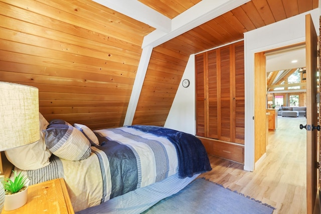 bedroom with beam ceiling, wooden ceiling, and hardwood / wood-style flooring