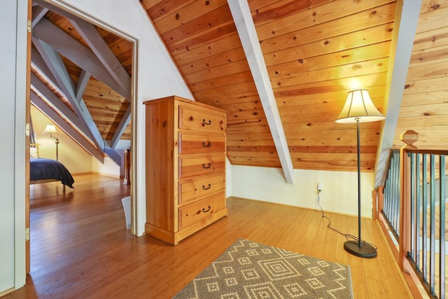 bonus room with hardwood / wood-style floors, vaulted ceiling with beams, and wood ceiling