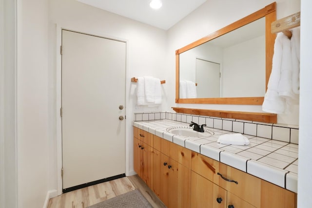 bathroom with vanity and hardwood / wood-style flooring