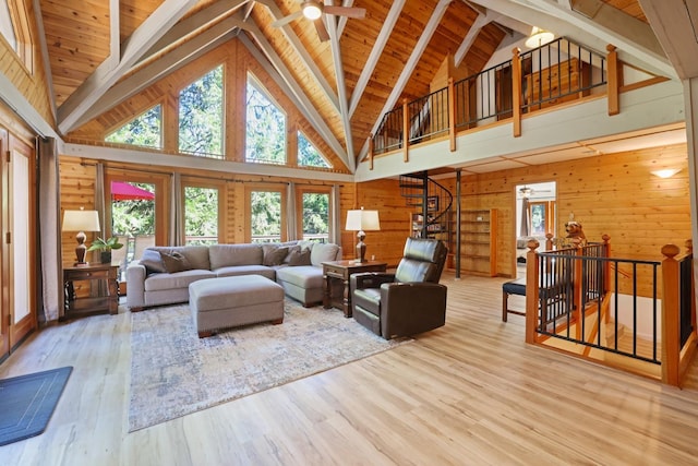 living room with wood ceiling, ceiling fan, light hardwood / wood-style flooring, high vaulted ceiling, and wood walls