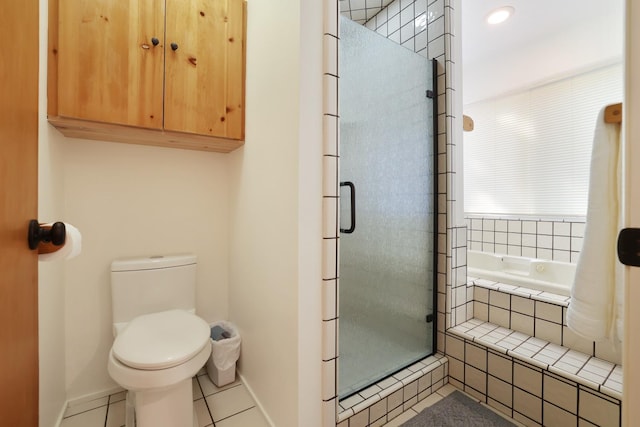 bathroom featuring toilet, tile patterned floors, and independent shower and bath