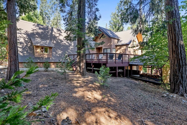 back of property featuring a wooden deck