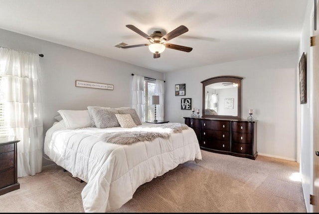 bedroom featuring light carpet, ceiling fan, and baseboards