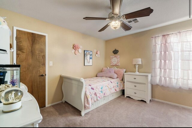 bedroom featuring light carpet, baseboards, visible vents, and a ceiling fan