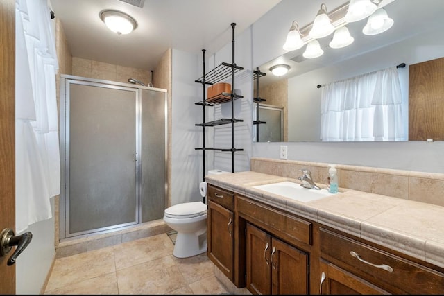 full bath with tile patterned flooring, toilet, vanity, and a shower stall