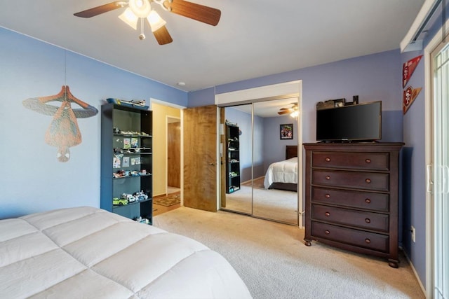 bedroom with a ceiling fan, a closet, and light colored carpet