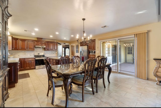 dining space featuring arched walkways, light tile patterned floors, recessed lighting, visible vents, and an inviting chandelier