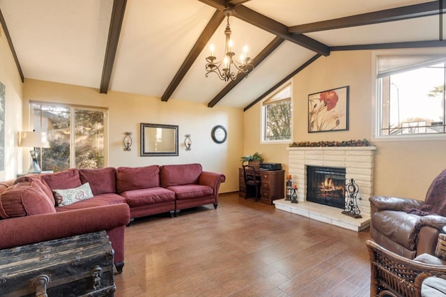 living area with lofted ceiling with beams, a fireplace, wood finished floors, and a notable chandelier