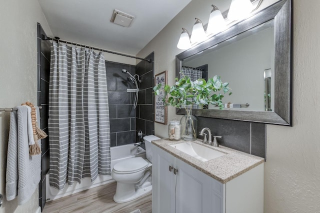 full bathroom featuring toilet, shower / tub combo with curtain, vanity, and hardwood / wood-style flooring