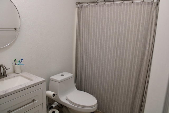 bathroom featuring vanity, a shower with shower curtain, and toilet