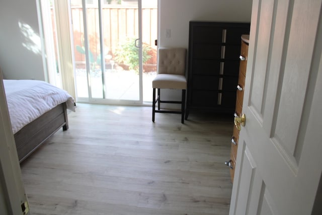 bedroom featuring access to exterior and light hardwood / wood-style flooring