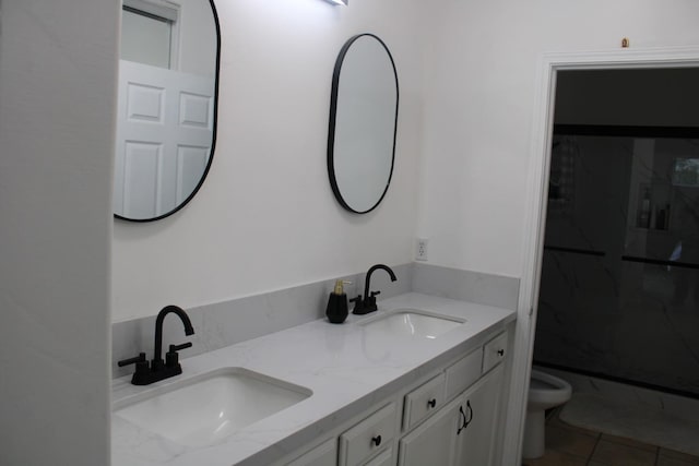 bathroom featuring tile patterned floors, vanity, toilet, and a shower